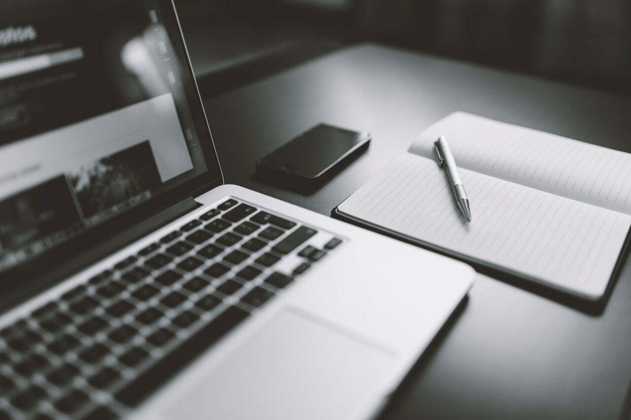 a laptop and a pen on a table