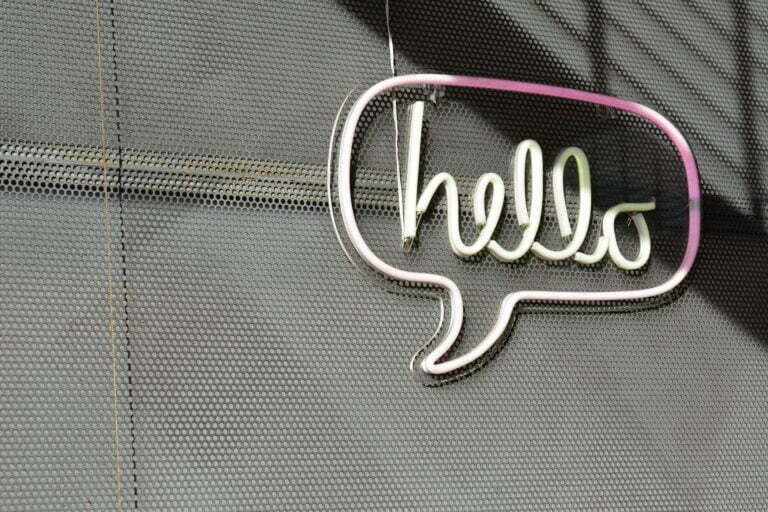 a white logo on a grey surface