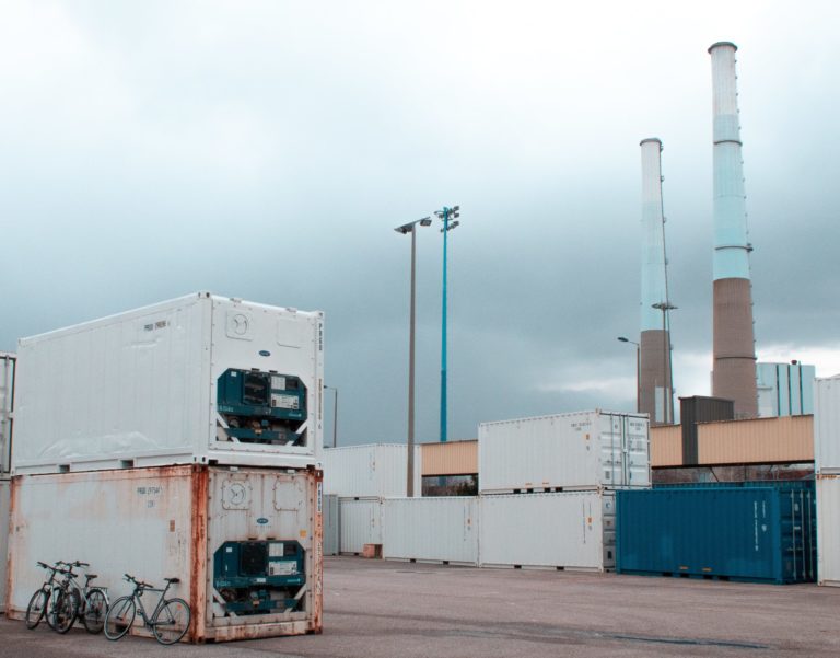 a large white container with a large tower in the background