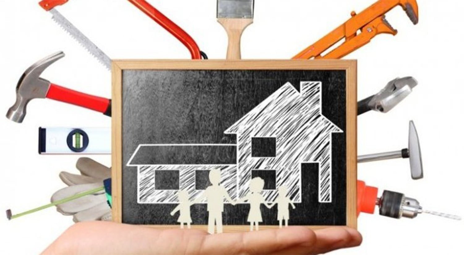 a hand holding a drawing of a house