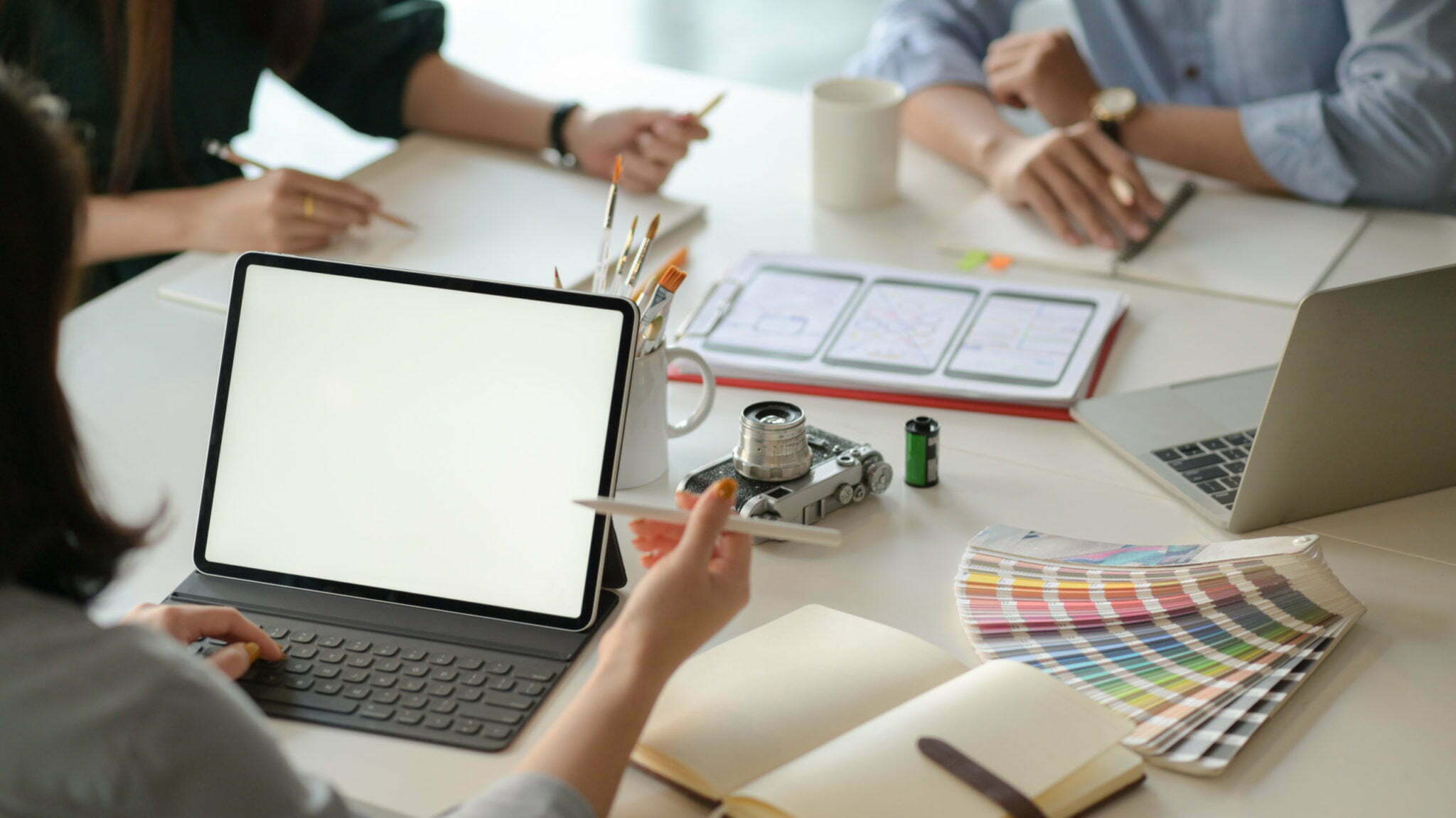 a group of people working on laptops
