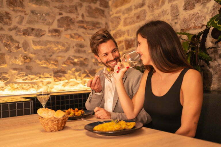 love in a restaurant, toasting glasses of wine, celebrating Valentine's Day