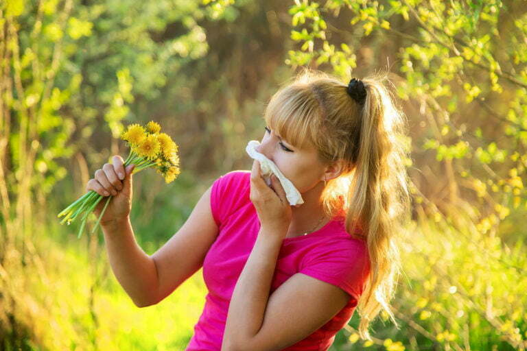 The woman is allergic to flowers. Selective focus.