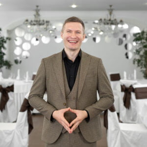 young cheerful man in a suit in a restaurant 2022 04 19 23 20 09 utc scaled