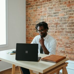 a man sitting at a table with a laptop
