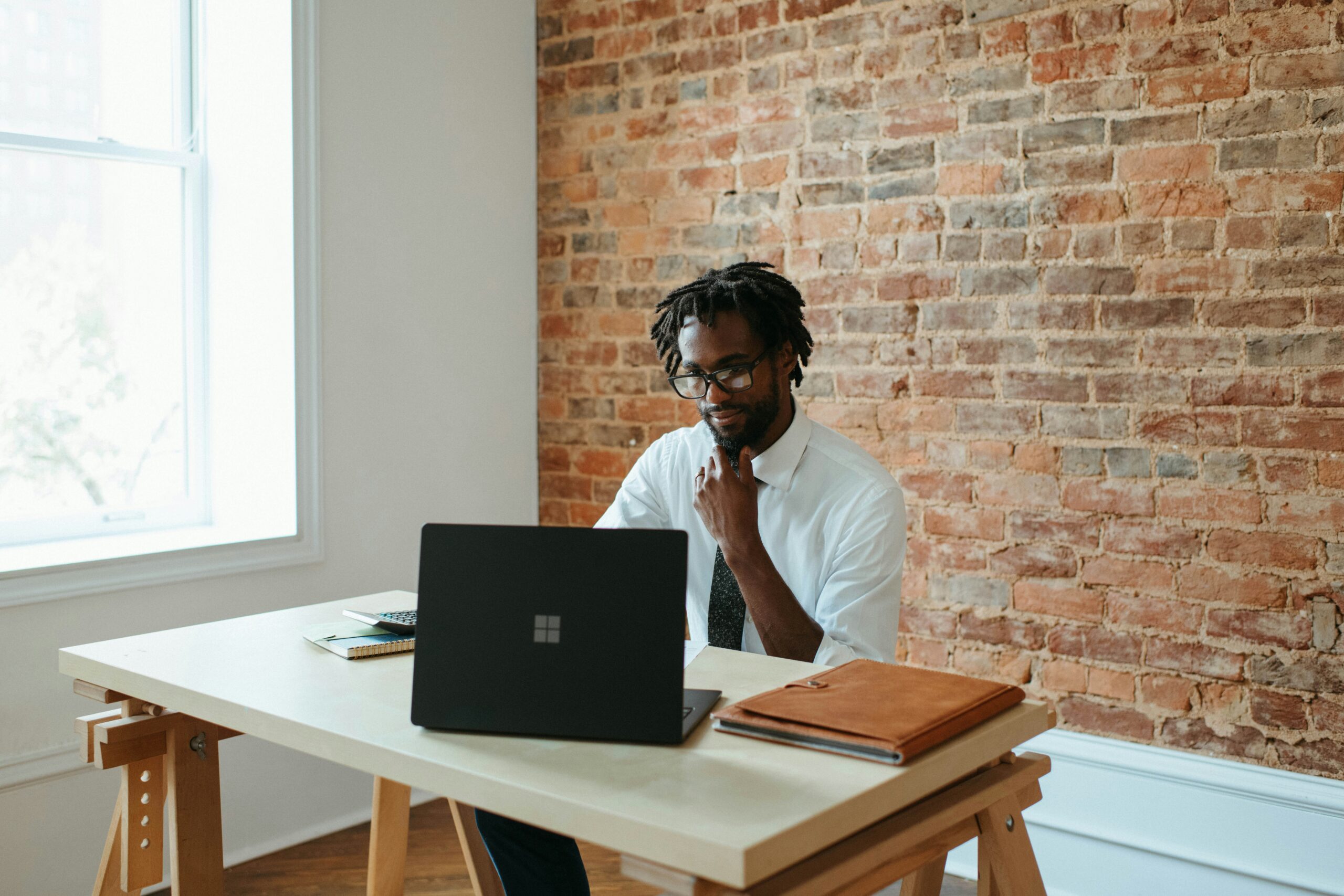 a man sitting at a table with a laptop